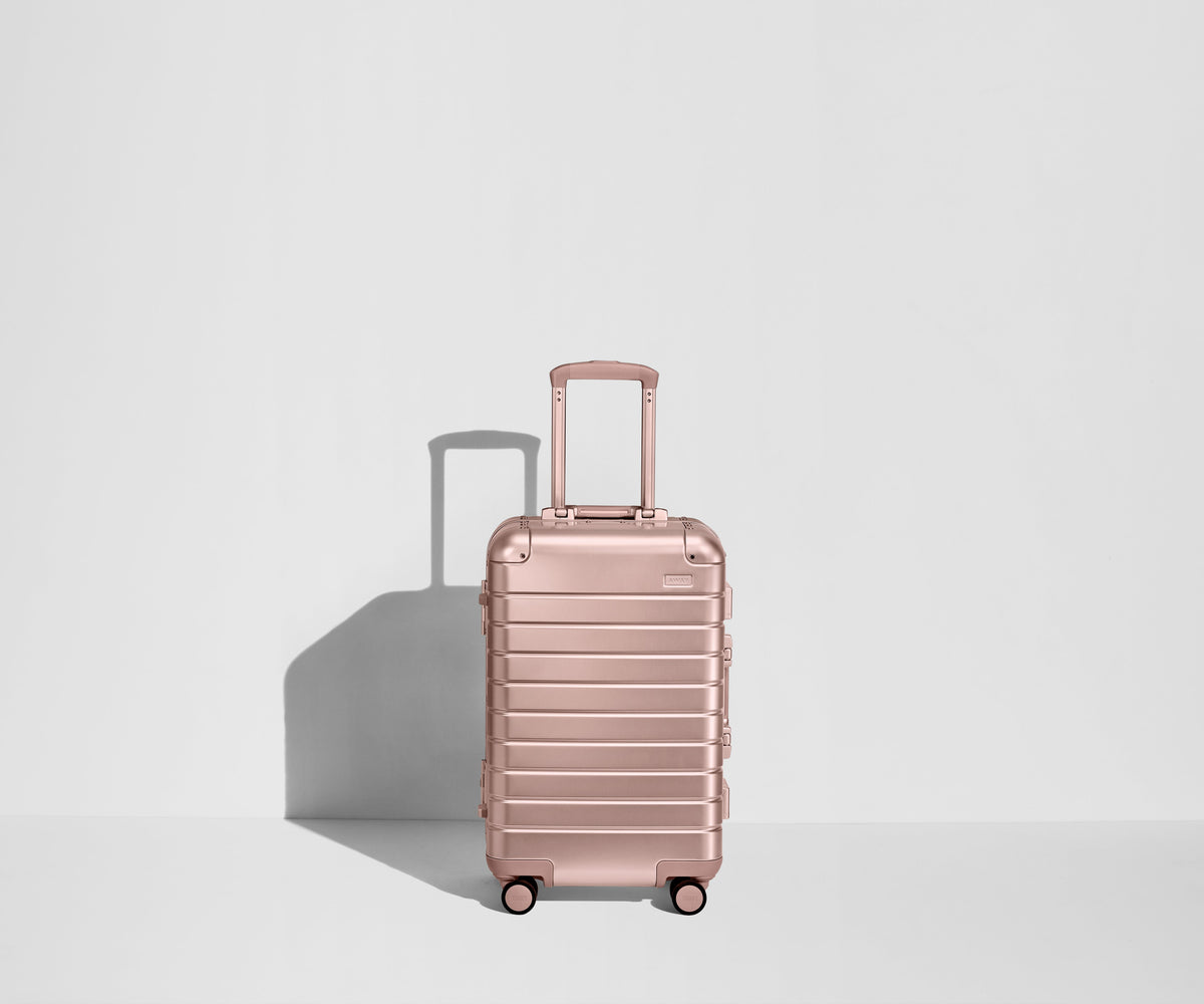 Away The Bigger Carry-On: Aluminum Edition Suitcase - Rose Gold (with USB charger)