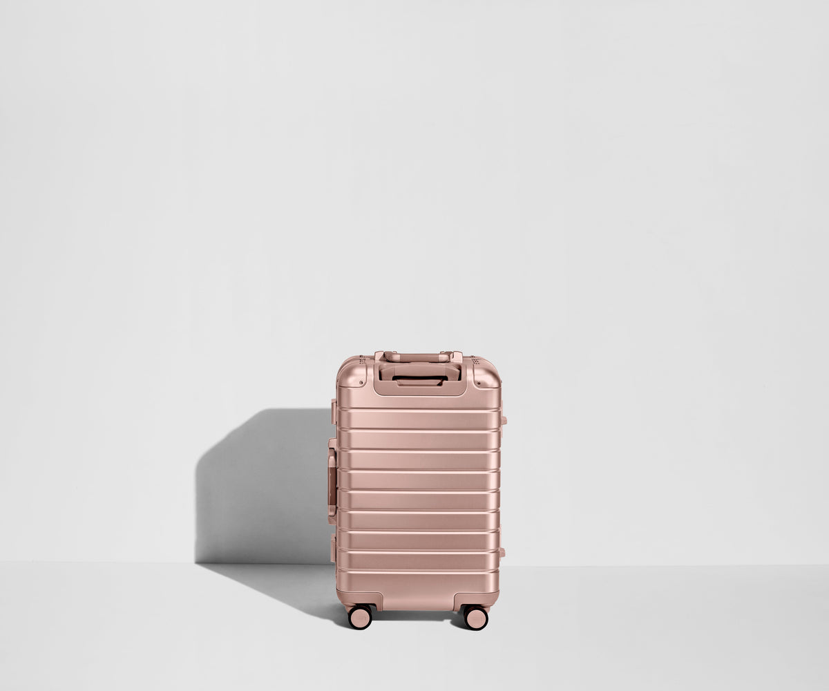 Away The Bigger Carry-On: Aluminum Edition Suitcase - Rose Gold (with USB charger)