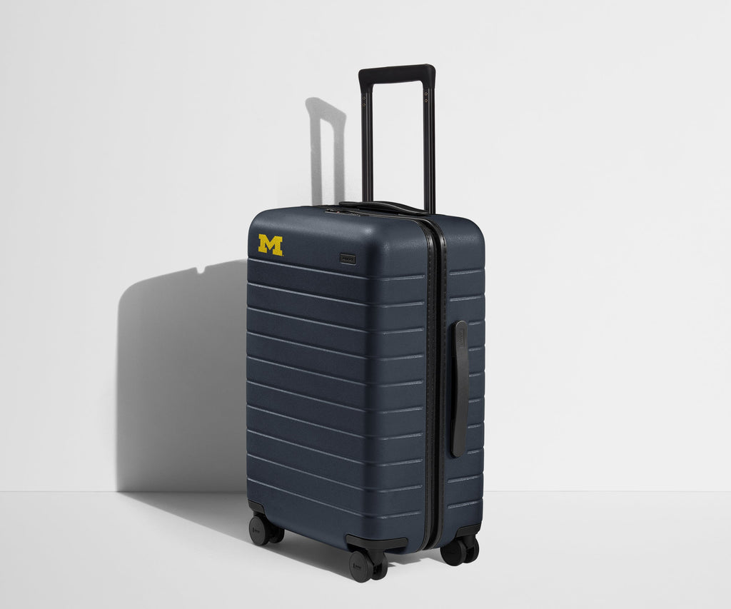 Away The Collegiate Bigger Carry-On Suitcase - University of Michigan ™